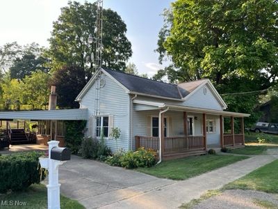 View of front of home with a front lawn and a porch | Image 1