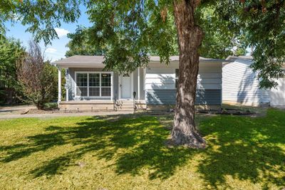 View of front facade featuring a front yard and a garage | Image 1