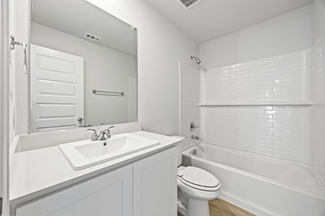 Bathroom featuring vanity, shower / tub combination, and wood finished floors | Image 14