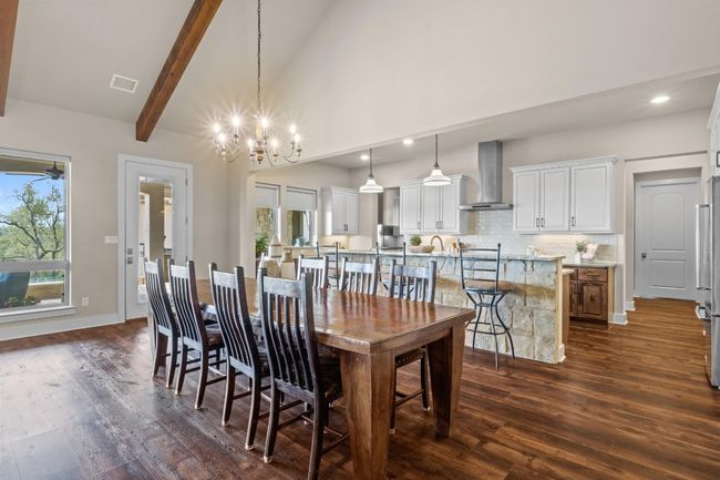 Dining room featuring beamed ceiling, a notable chandelier, dark wood-type flooring, visible vents, and recessed lighting | Image 9