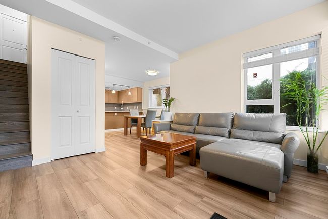 Living area featuring light wood finished floors, stairs, and baseboards | Image 4