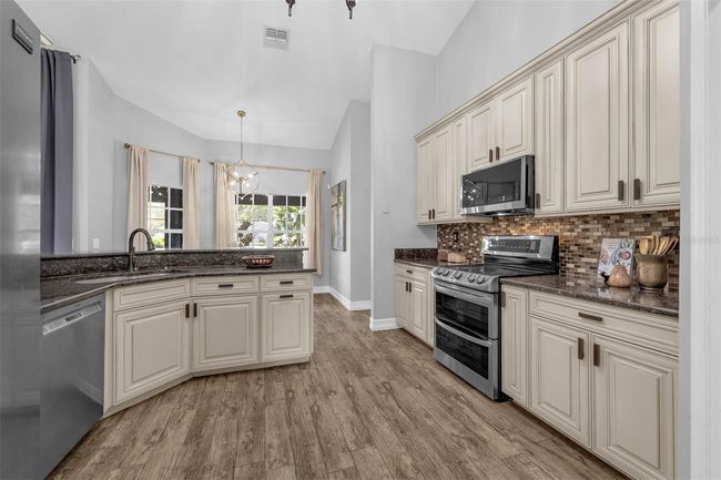 Tall Cabinets and Beautiful Backsplash adds to the beauty of this kitchen | Image 10