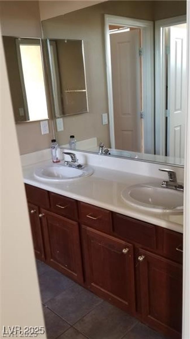Full bath featuring double vanity and dark tile patterned floors | Image 28