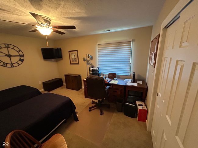bedroom featuring a ceiling fan, visible vents, and carpet | Image 10