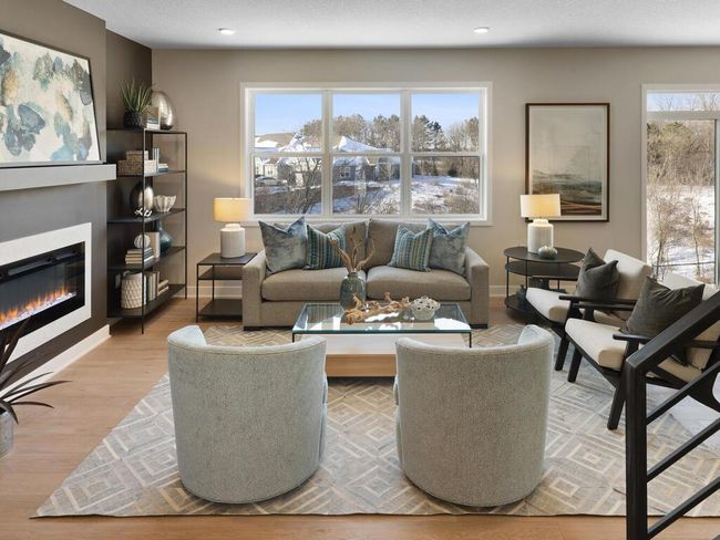 The spacious family room offers a cozy yet open atmosphere, ideal for both relaxing and entertaining. With large windows that flood the space with natural light and a stylish design, it’s the perfect place to create lasting memories. | Image 7