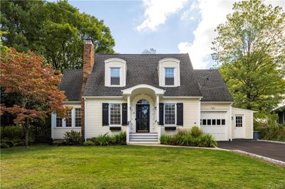 View of front of property featuring a front yard and a garage | Image 1