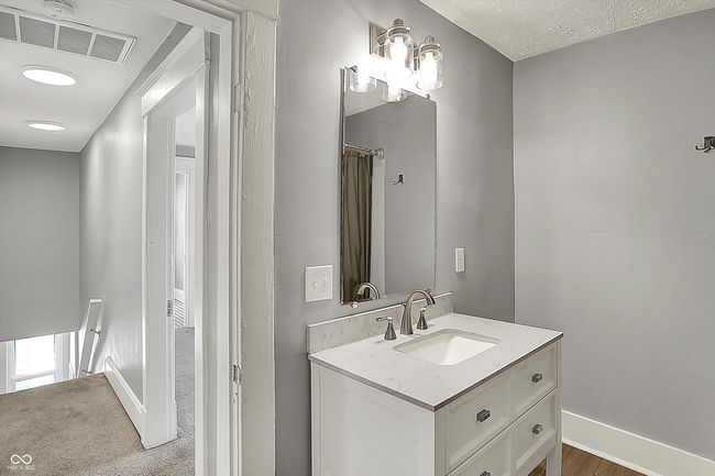 bathroom with baseboards, visible vents, and vanity | Image 36