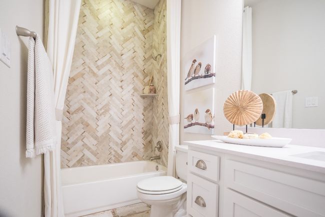 Bathroom featuring vanity, tub / shower combination, and toilet | Image 24