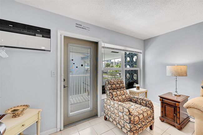 You have 3 Newer Friedrich Wall AC Units, 1 with Heat, Impact Windows and Doors with Blinds and Retractable Screen Doors. The Chair by the Front Door is a Very Comfortable Recliner! Being Sold Furnished and Turn-Key! | Image 31