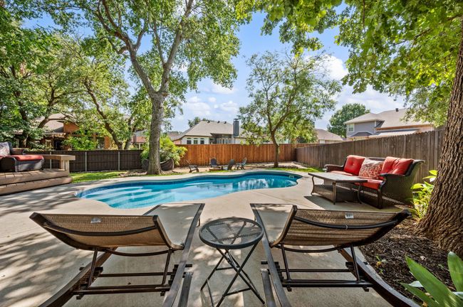 View of swimming pool with a patio, a fenced backyard, and an outdoor hangout area | Image 31