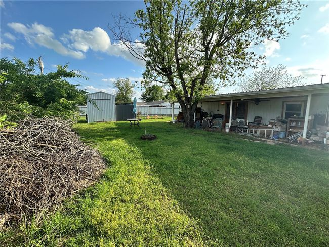 View of yard with a storage shed and covered patio | Image 22