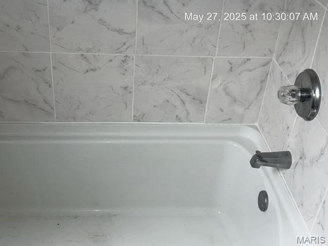 Bathroom view of a bath and a shower | Image 13