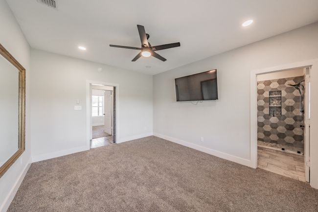Unfurnished bedroom featuring carpet flooring, recessed lighting, baseboards, a ceiling fan, and ensuite bath | Image 29