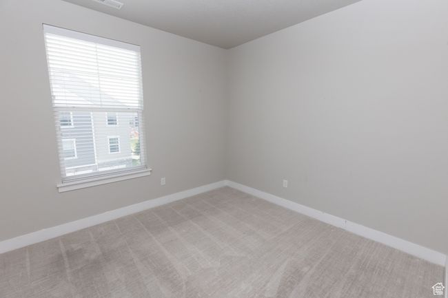 Empty room featuring healthy amount of natural light, light carpet, and baseboards | Image 15