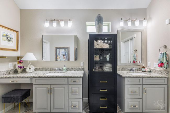 The primary bathroom features a dual sink setup, offering ample space and convenience for two. The design is both functional and elegant, with fixtures that complement the sophisticated aesthetic of the room. | Image 24
