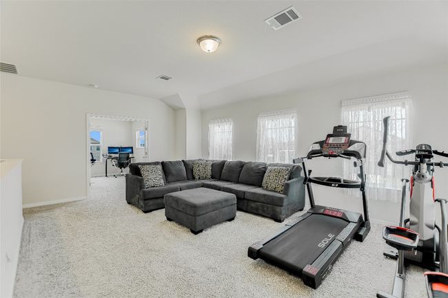Exercise area with carpet flooring and baseboards | Image 16
