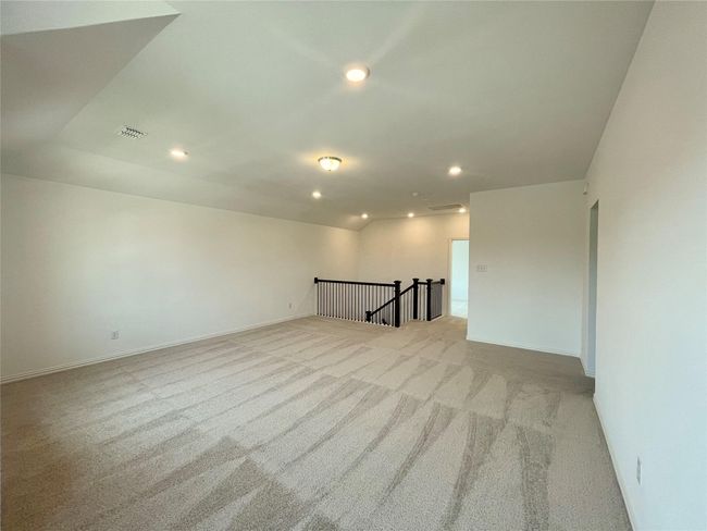 Unfurnished room with light carpet, recessed lighting, and lofted ceiling | Image 16