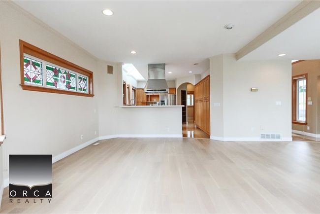 Unfurnished living room featuring arched walkways, light wood-style flooring, and recessed lighting | Image 14