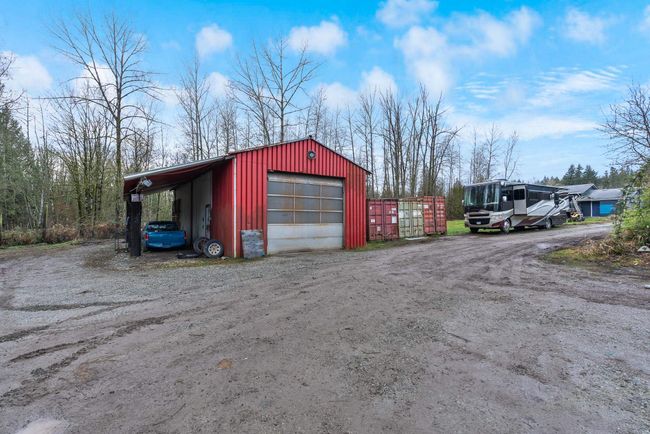 Garage featuring a detached garage and dirt driveway | Image 30