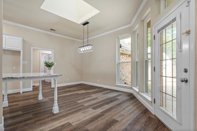 The breakfast area has access to the back patio and a large counter extension that can serve as seating. | Image 11