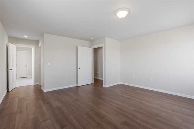 Unfurnished bedroom featuring baseboards, recessed lighting, and dark wood finished floors | Image 46