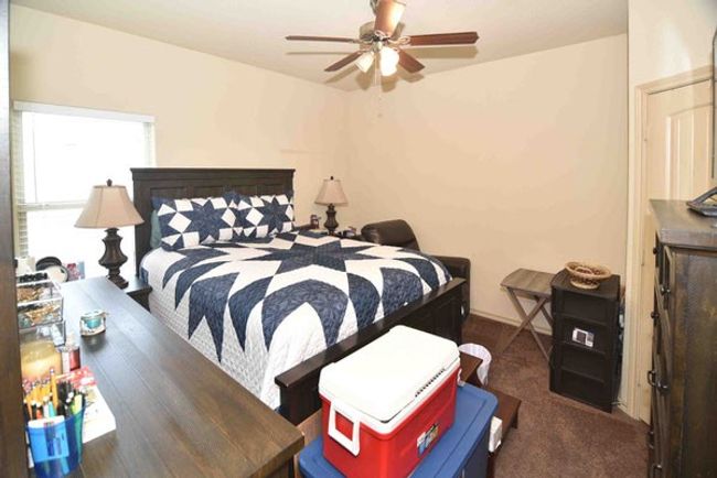 Carpeted bedroom featuring a ceiling fan | Image 27
