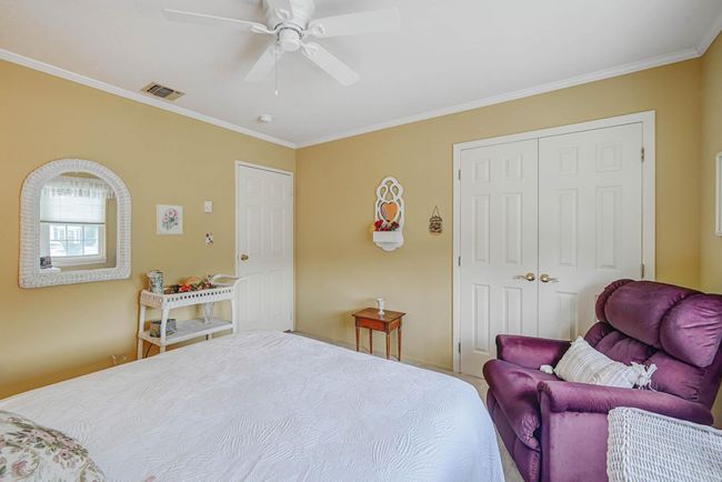 Bedroom featuring crown molding, a closet, and a ceiling fan | Image 12