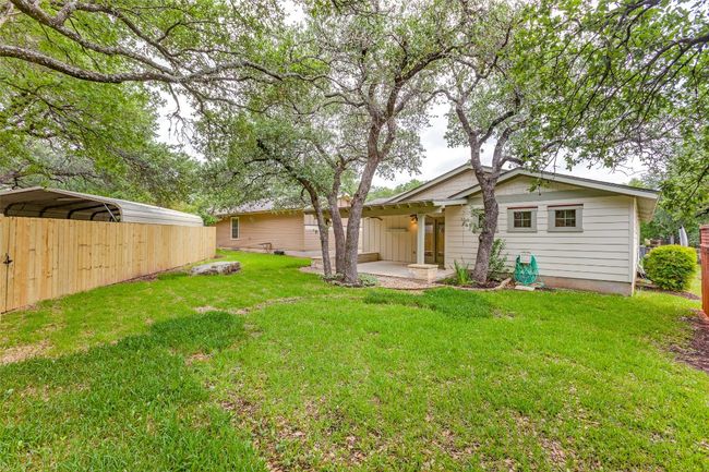 View of green lawn with a carport and a patio | Image 32