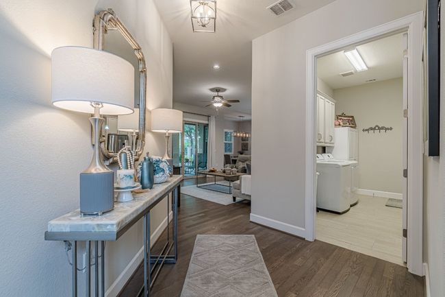 Hall with washer / dryer, dark wood-type flooring, baseboards, and recessed lighting | Image 4