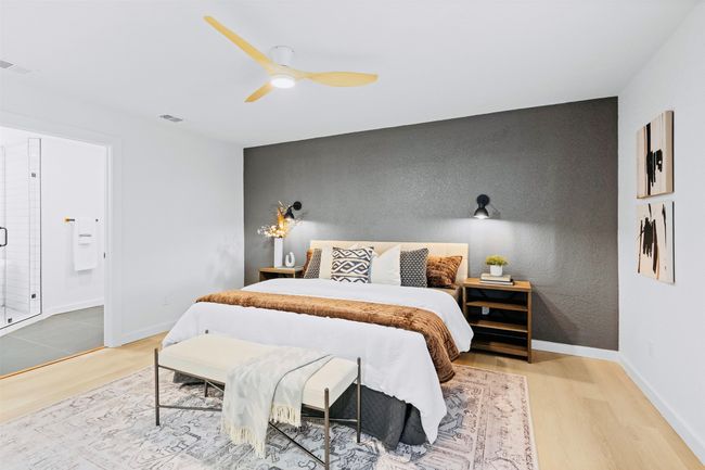 Bedroom featuring wood finished floors, a ceiling fan, an accent wall, and ensuite bath | Image 17