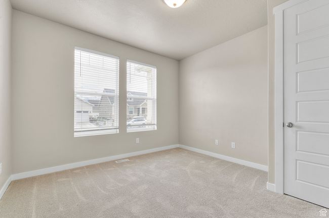 Empty room featuring visible vents, light colored carpet, and baseboards | Image 6