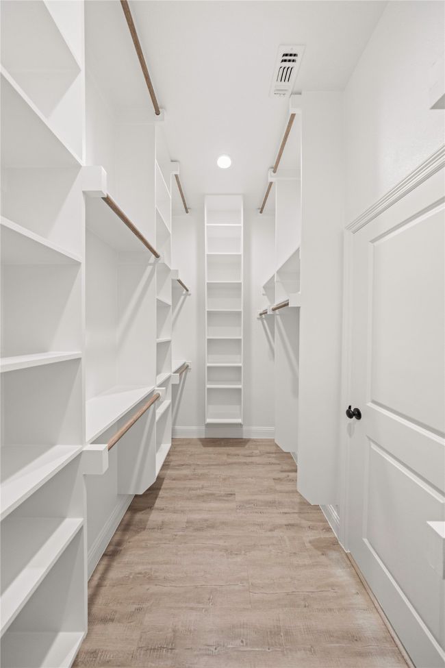 Walk in closet with light wood finished floors | Image 24