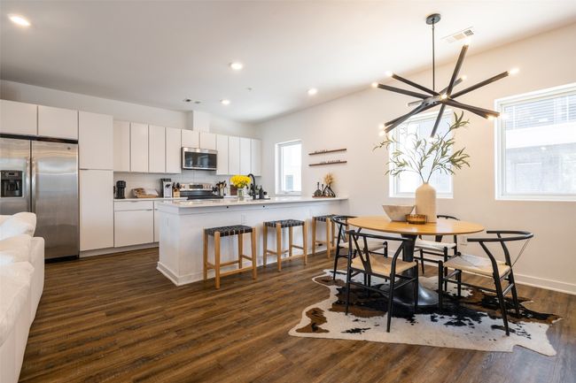 Dining space with dark wood finished floors, visible vents, and recessed lighting | Image 7