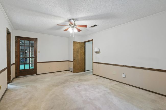 Unfurnished room with carpet floors, a ceiling fan, a textured ceiling, and visible vents | Image 25