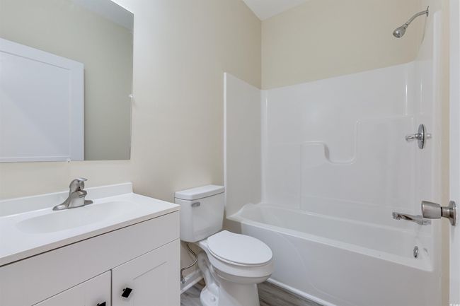 Bathroom with vanity, toilet, shower / bath combination, and wood finished floors | Image 16