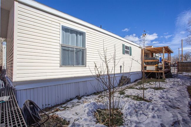 View of snow covered exterior with a wooden deck | Image 17