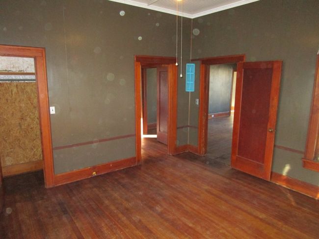 Empty room with baseboards, wood finished floors, and crown molding | Image 13