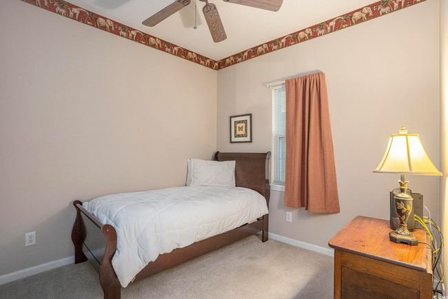Bedroom with carpet, baseboards, and a ceiling fan | Image 12
