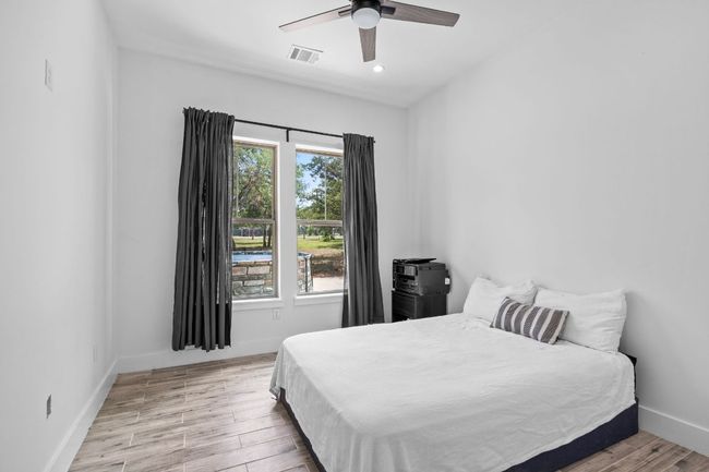 Bedroom with wood floors, recessed lighting, and a ceiling fan | Image 20