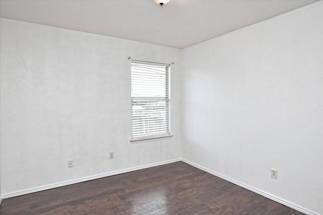 Unfurnished room featuring wood finished floors and baseboards | Image 21
