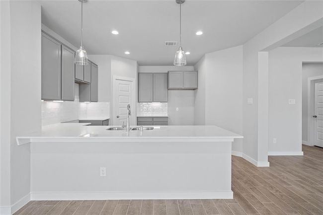 Any chef's dream, this stunning kitchen is perfect for everyday life as well as entertaining family and friends! Extra large counter space is perfect for conversation or that much needed space to lay out your party spread for everyone to enjoy! | Image 6