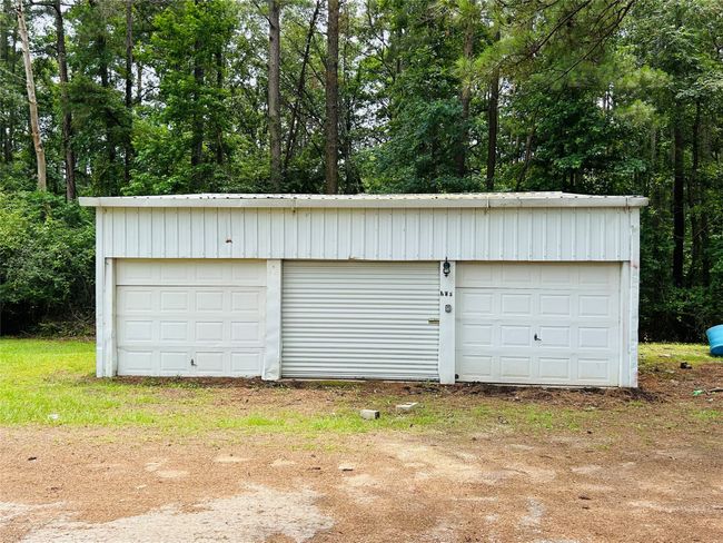 Detached garage featuring view of scattered trees | Image 8