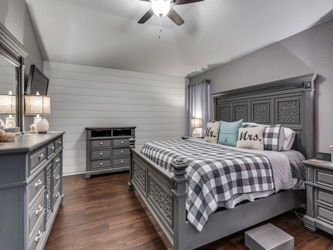 Bedroom featuring dark wood finished floors, lofted ceiling, and a ceiling fan | Image 16