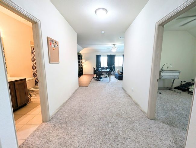 Hallway with a desk and light colored carpet | Image 5