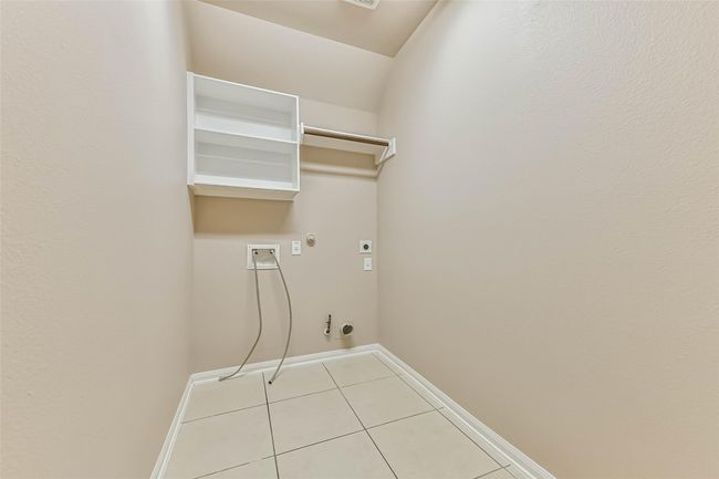 laundry room on split side with bedrooms 2, 3, 4 | Image 34