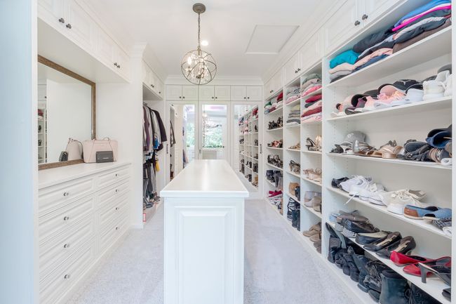 Walk in closet featuring a chandelier | Image 30