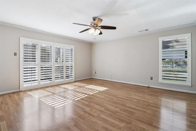 The Primary Bedroom offers a light and bright atmosphere with plantation shutters | Image 17