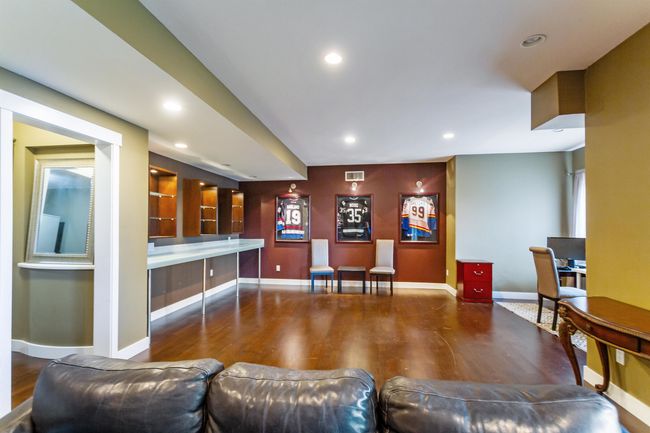 Bar with recessed lighting, baseboards, visible vents, and wood finished floors | Image 26