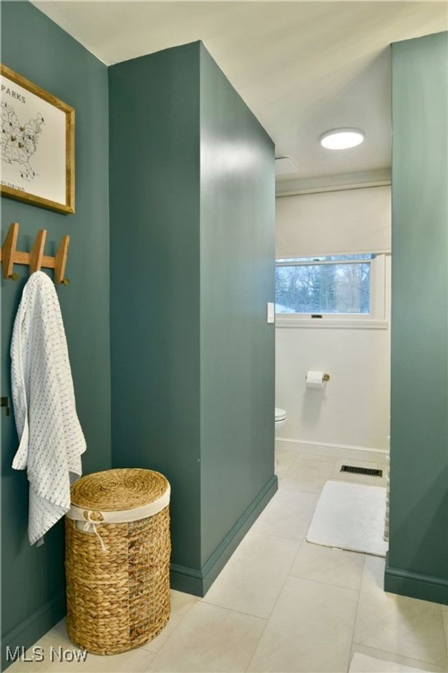 Bathroom featuring visible vents, toilet, tile patterned flooring, and baseboards | Image 34
