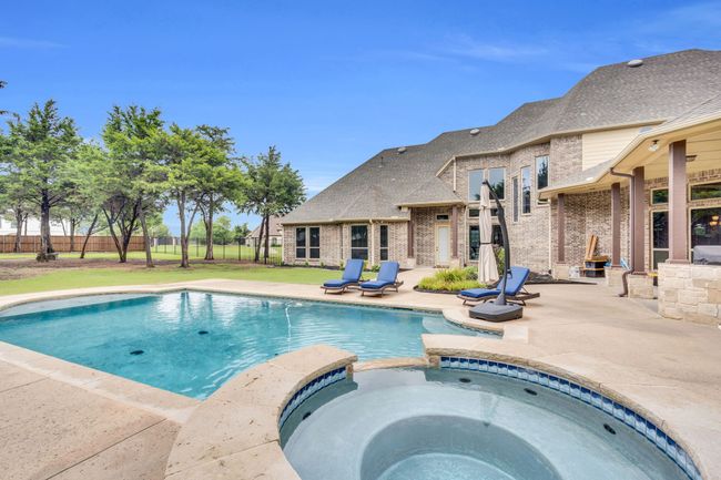View of pool featuring a patio and a pool with connected hot tub | Image 38